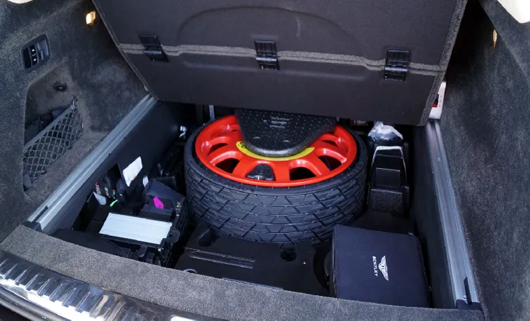 how to put a spare tire back in the trunk