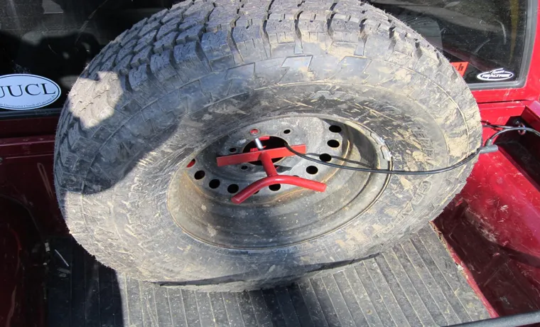 how to put a spare tire back under the truck