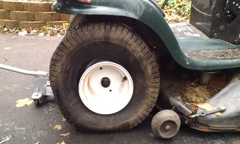 how to take a lawn mower tire off